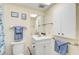 Bathroom featuring a vanity with storage, a mirror, and blue towels at 708 Tamiami S Trl # 115, Venice, FL 34285