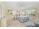 Bright bedroom with a beach theme, featuring a comfortable bed, two windows, and a desk at 708 Tamiami S Trl # 115, Venice, FL 34285