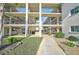 Beautiful building entrance with landscaped walkway and common area at 708 Tamiami S Trl # 115, Venice, FL 34285
