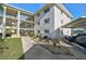 Building exterior with covered parking and garden at 708 Tamiami S Trl # 115, Venice, FL 34285