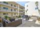 Outdoor courtyard with comfortable lounge seating and a grill at 708 Tamiami S Trl # 115, Venice, FL 34285