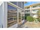 Condo exterior with screened-in lanai, well-maintained landscaping, and inviting curb appeal at 708 Tamiami S Trl # 115, Venice, FL 34285