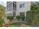 Building's exterior showcasing well-manicured shrubs and landscaping for an inviting curb appeal at 708 Tamiami S Trl # 115, Venice, FL 34285