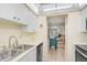 Functional kitchen with appliances and a view into the adjoining dining and living spaces at 708 Tamiami S Trl # 115, Venice, FL 34285