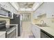 Efficient kitchen featuring essential appliances, and ample cabinet space at 708 Tamiami S Trl # 115, Venice, FL 34285