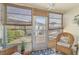 Enclosed lanai with wicker chairs, offering a serene view of the pool and patio area at 708 Tamiami S Trl # 115, Venice, FL 34285