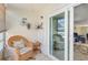 Relaxing lanai with comfortable wicker seating and views through sliding glass doors at 708 Tamiami S Trl # 115, Venice, FL 34285