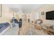 Bright living room with open floor plan, view of dining area and comfortable seating at 708 Tamiami S Trl # 115, Venice, FL 34285
