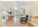 Bright living room featuring an open floor plan, comfortable seating, and a view to the balcony at 708 Tamiami S Trl # 115, Venice, FL 34285