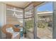 Enclosed porch with natural lighting and a comfortable wicker chair at 708 Tamiami S Trl # 115, Venice, FL 34285