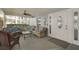 Relaxing covered porch with comfortable seating and ceiling fan at 708 Tamiami S Trl # 115, Venice, FL 34285
