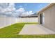 The backyard features a grassy lawn and a concrete patio at 711 Brenton Leaf Dr, Ruskin, FL 33570