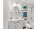 Well-maintained bathroom with a bathtub, shower, vanity with modern fixtures, and a decorative mirror at 711 Brenton Leaf Dr, Ruskin, FL 33570