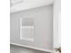 Bedroom features gray vinyl floors, white trim and a window at 711 Brenton Leaf Dr, Ruskin, FL 33570