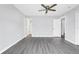Spacious bedroom with gray vinyl flooring, ceiling fan, and ensuite bathroom at 711 Brenton Leaf Dr, Ruskin, FL 33570