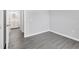 Bedroom with en-suite bathroom features gray vinyl floors, a double door and doorway to the bathroom at 711 Brenton Leaf Dr, Ruskin, FL 33570
