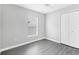 This bedroom boasts gray vinyl flooring, a ceiling fan, and double-door closet, window with blinds at 711 Brenton Leaf Dr, Ruskin, FL 33570