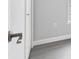 Hallway features gray vinyl floors and a door to a room with a window at 711 Brenton Leaf Dr, Ruskin, FL 33570