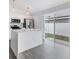 Bright, modern kitchen with stainless steel appliances, white cabinetry, and quartz countertops at 711 Brenton Leaf Dr, Ruskin, FL 33570