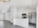 Open concept kitchen features a modern design with stainless steel appliances and island with bar seating at 711 Brenton Leaf Dr, Ruskin, FL 33570