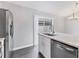 Modern kitchen with a sink and dishwasher with a sliding glass door behind the counter at 711 Brenton Leaf Dr, Ruskin, FL 33570