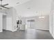 This is a spacious living room with an open layout that connects to the kitchen and has gray vinyl flooring at 711 Brenton Leaf Dr, Ruskin, FL 33570