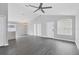 Open concept living area features gray vinyl flooring, high ceilings, and ample natural light at 711 Brenton Leaf Dr, Ruskin, FL 33570