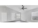 Spacious living room with high ceilings, fan, and natural light from a window at 711 Brenton Leaf Dr, Ruskin, FL 33570
