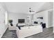Bright and airy living room with stylish furniture, ceiling fan, and large windows for natural light at 711 Brenton Leaf Dr, Ruskin, FL 33570