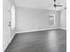 Bright living room featuring modern gray vinyl flooring, a ceiling fan, and natural light at 711 Brenton Leaf Dr, Ruskin, FL 33570