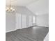 Bright living room with vaulted ceilings and new gray floors, chandelier included at 711 Brenton Leaf Dr, Ruskin, FL 33570