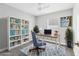 Well-lit home office featuring a desk, bookshelf, and comfortable decor, creating an ideal workspace at 711 Brenton Leaf Dr, Ruskin, FL 33570