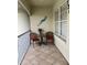 Balcony with seating and tile floor, overlooking manicured landscaping at 7201 L Pavia Blvd # 7201, Venice, FL 34292