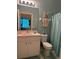 Bathroom featuring blue walls, vanity, toilet and shower with patterned curtain at 7201 L Pavia Blvd # 7201, Venice, FL 34292