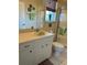 Well-lit bathroom featuring a single sink vanity, walk-in shower, and neutral tones for a clean, fresh feel at 7201 L Pavia Blvd # 7201, Venice, FL 34292