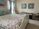 Bright bedroom with a white bed frame, coastal-themed decor, and a study area with a desk at 7201 L Pavia Blvd # 7201, Venice, FL 34292