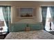 Close-up on a bedroom showcasing a bed with decorative pillows and coastal-themed window art at 7201 L Pavia Blvd # 7201, Venice, FL 34292