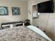 The Primary bedroom view of ensuite bathroom, coastal-themed decor, and a study area with a desk at 7201 L Pavia Blvd # 7201, Venice, FL 34292