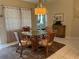 Dining room with glass table and view into the Primary bedroom at 7201 L Pavia Blvd # 7201, Venice, FL 34292