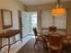 Dining room with glass table, view of the front door and screened in balcony at 7201 L Pavia Blvd # 7201, Venice, FL 34292