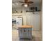 Bright kitchen with white cabinets, appliances, tile floor and center island at 7201 L Pavia Blvd # 7201, Venice, FL 34292