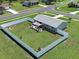 Aerial view of home featuring backyard patio with lawn and vinyl privacy fence at 7505 Wexford St, North Port, FL 34287