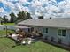 Back patio featuring a shade covering, dining table, and planters offers a relaxing outdoor space at 7505 Wexford St, North Port, FL 34287