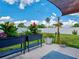 Landscaped backyard patio area and manicured lawn with a white fence at 7505 Wexford St, North Port, FL 34287
