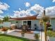Backyard patio features an outdoor dining area, barbecue, and a shade structure at 7505 Wexford St, North Port, FL 34287