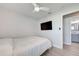 Bedroom features a television and a door leading to a bathroom with a vanity at 7505 Wexford St, North Port, FL 34287