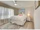 Comfortable bedroom with a neutral palette, a ceiling fan and a bright window with decorative curtains at 7505 Wexford St, North Port, FL 34287