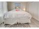 A bright bedroom featuring neutral colors, a large bed, and natural light from the window at 7505 Wexford St, North Port, FL 34287