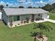 Charming single-story home featuring a manicured lawn and beautiful landscaping at 7505 Wexford St, North Port, FL 34287