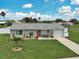 Charming single-story home featuring a manicured lawn and beautiful landscaping at 7505 Wexford St, North Port, FL 34287